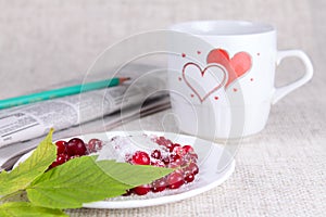 Cowberry in sugar against a mug with hearts