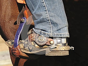 Cowboy boot in saddle stirrup