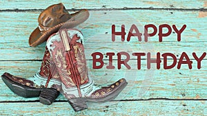 Cowboy boots and hat on a teal background