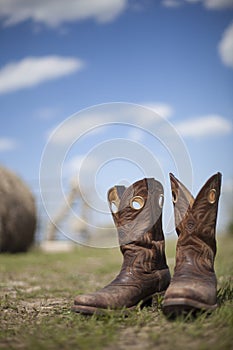 Cowboy boots in pasture