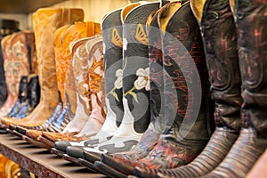 Cowboy boots on a shelf in a store aligned