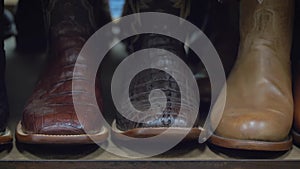 Cowboy boots on a shelf in store aligned, closeup.