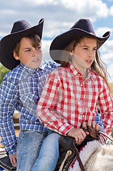 cowboy brother and sister closeup portrait on