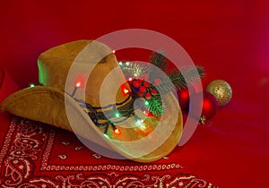 Cowboy Christmas.American West hat and bandanna on christmas red