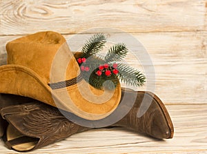Cowboy Christmas.American West traditional boots and hat on wood