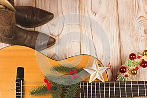 Cowboy christmas background with guitar and cowboy boots