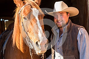 Cowboy close to horses head, on ranch, British Colombia, Canada, North America