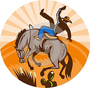 Cowboy falling horse in desert