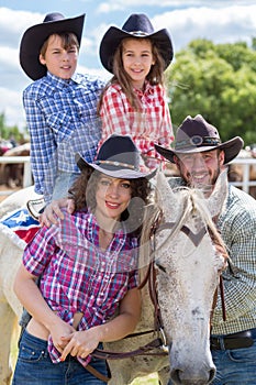 cowboy family of four with a horse