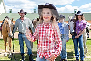 cowboy girl with ok gesture closeup portrait on