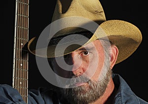 A Cowboy with a Gray Beard and a Guitar