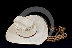 Cowboy hat and lasso on black