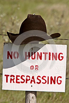 Cowboy hat over posted sign