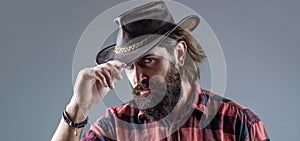 Cowboy Hat. Portrait of young man wearing cowboy hat. Cowboys in hat. Handsome bearded macho. Man unshaven cowboys