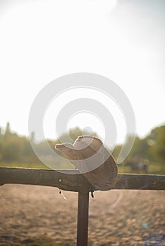 Cowboy hat on the ranch. The fence on the farm