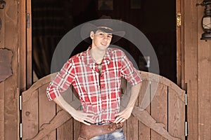 Cowboy in hat standing near saloon entrance