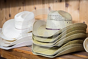 Cowboy hats on a wooden shelf in a store