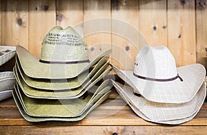 Cowboy hats on a wooden shelf in a store