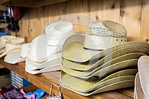 Cowboy hats on a wooden shelf in a store