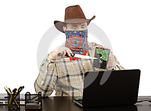Cowboy holding a knife and hard disk threats on Skype photo