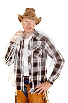 Cowboy holding rope over shoulder looking