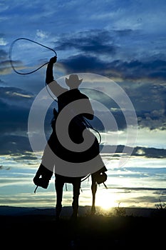 Cowboy on horse facing roping