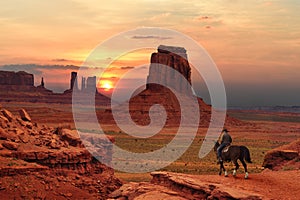 A cowboy on a horse at sunset in Monument Valley Tribal Park in Utah-Arizona border, USA