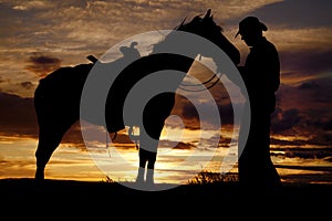 Cowboy horse sunset stand