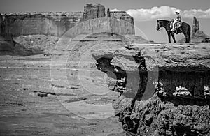 Cowboy on horseback in Monument Valley photo