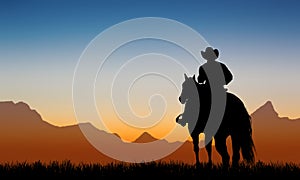 Cowboy on horseback at sunset