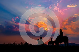 Cowboy on horseback with views of the mountains and sunset sky