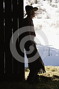 Cowboy Leaning in Doorway of Barn