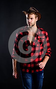 Cowboy life came to be highly romanticized. Adopt cowboy mannerisms as a fashion pose. Man unshaven cowboy black photo