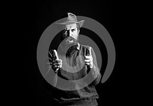 Cowboy man shouting with hand pistol gun pistogesture. Cowboy man in cowboy hat. Wild west guns, finger revolver