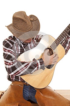 Cowboy play guitar close