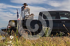 Cowboy Rancher Preparing Ropes on Back of His Pickup Truck
