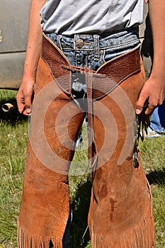 Cowboy in riding chaps at a roundup