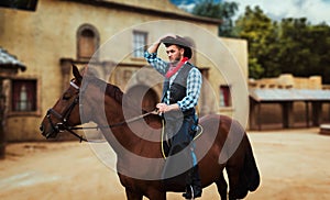 Cowboy riding a horse in texas country, saloon