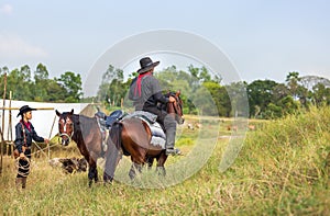 Cowboy`s way of life include riding a horse around locales