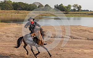 Cowboy`s way of life include riding a horse around locales