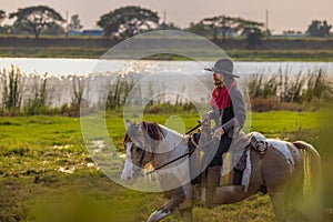 Cowboy`s way of life include riding a horse around locales