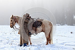 Cowboy shooting across his saddle