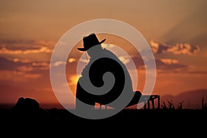 Cowboy silhouette against sunrise
