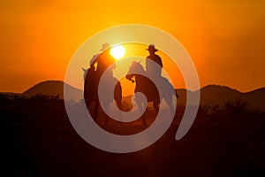 Cowboy silhouette riding a horse.