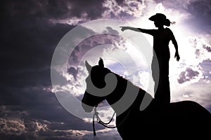 Cowboy Silhouette Standing on Horse