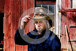 Cowboy Tipping Hat in front of Barn