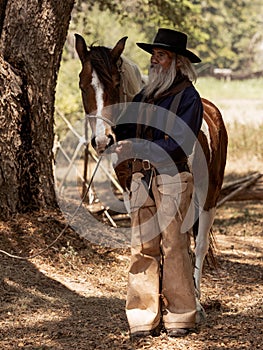 Cowboy touches the horse with love