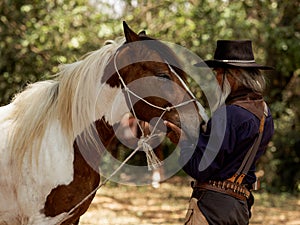 Cowboy touches the horse with love