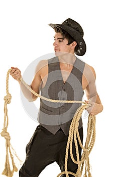 Cowboy in vest with rope look side