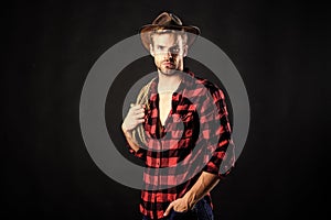 Cowboy wearing hat hold rope. Lasso tool of American cowboy. Still used on ranches to capture cattle or other livestock photo